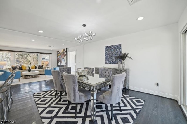 dining area featuring dark wood-style floors, visible vents, baseboards, recessed lighting, and a notable chandelier