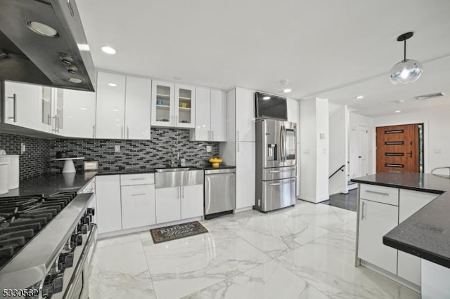 kitchen featuring dark countertops, under cabinet range hood, appliances with stainless steel finishes, marble finish floor, and a sink