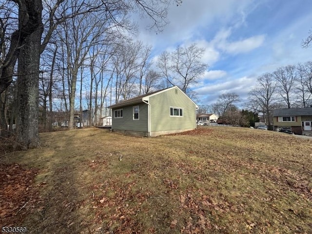 view of home's exterior with a yard