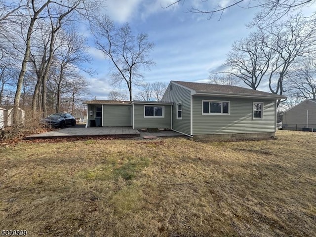 back of house with a yard and a patio