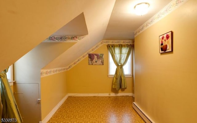 additional living space with baseboard heating and vaulted ceiling