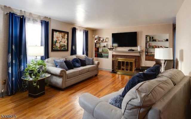 living room with a fireplace and hardwood / wood-style flooring