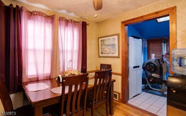 dining area with ceiling fan and light wood-type flooring