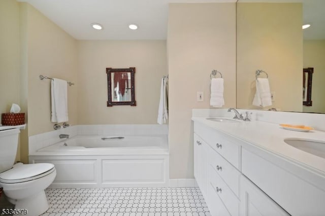 bathroom featuring vanity, a bathtub, and toilet