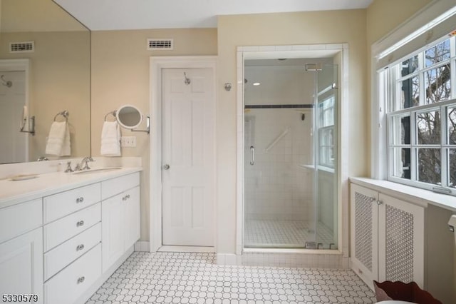 bathroom featuring vanity and an enclosed shower