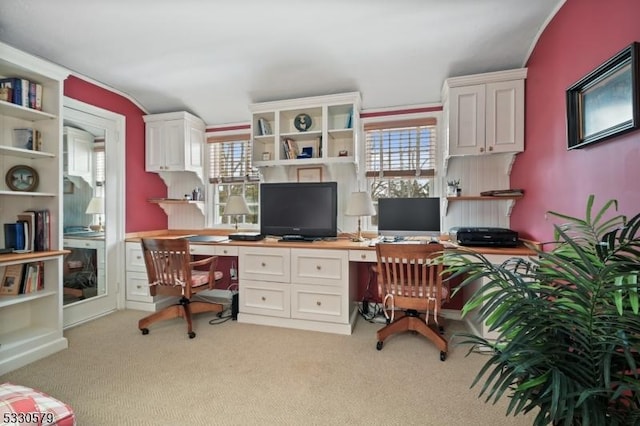 carpeted office featuring built in desk