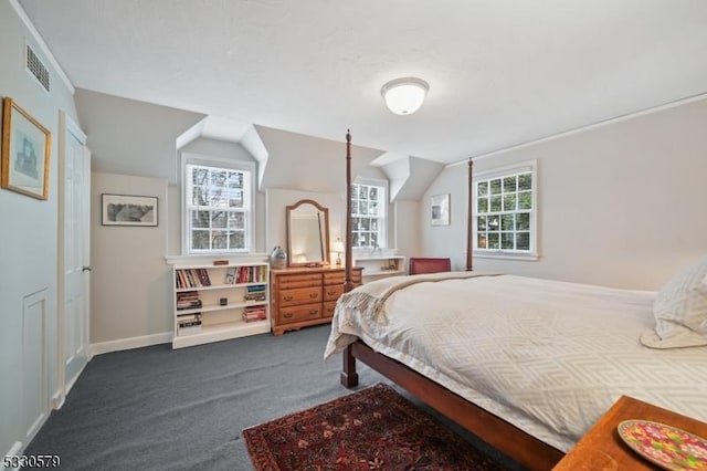 carpeted bedroom with lofted ceiling