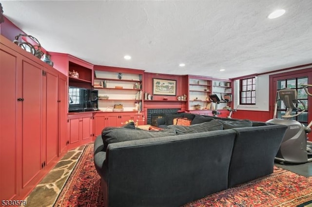 living room with built in features and a textured ceiling