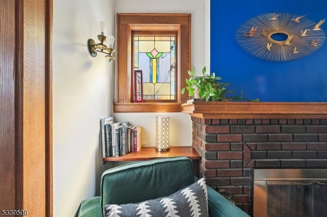 sitting room featuring a brick fireplace