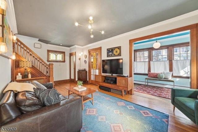 living area featuring stairway, a baseboard heating unit, and wood finished floors