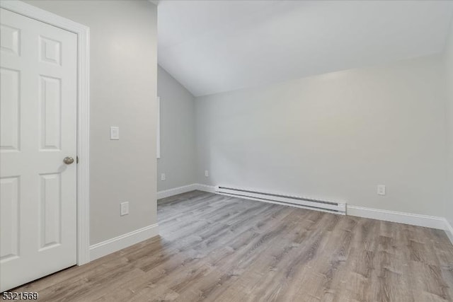 bonus room with baseboard heating, light hardwood / wood-style flooring, and vaulted ceiling