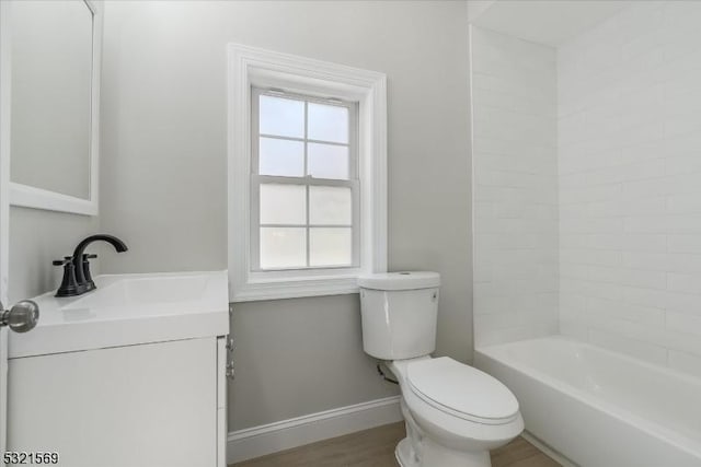 full bathroom featuring hardwood / wood-style floors, vanity, toilet, and shower / washtub combination