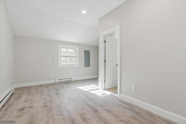 unfurnished room featuring electric panel, a baseboard radiator, and light hardwood / wood-style flooring