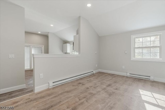 bonus room featuring lofted ceiling, baseboard heating, and light hardwood / wood-style flooring