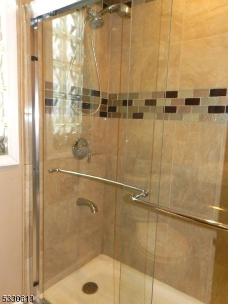 bathroom featuring a shower with door