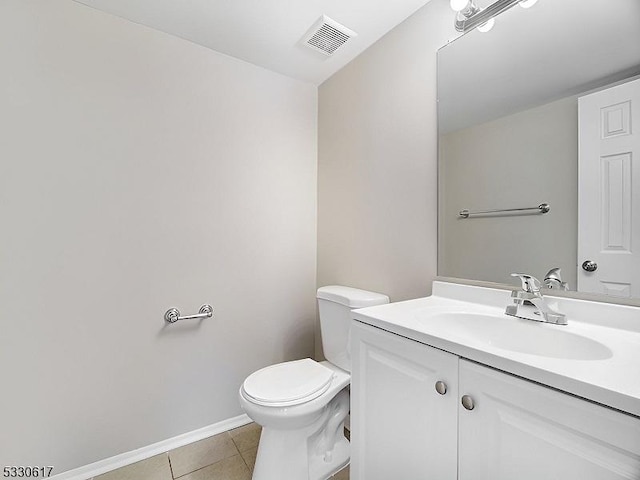 bathroom featuring tile patterned flooring, vanity, and toilet