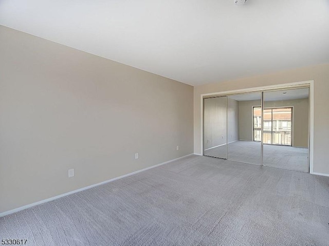 interior space with light colored carpet and a closet