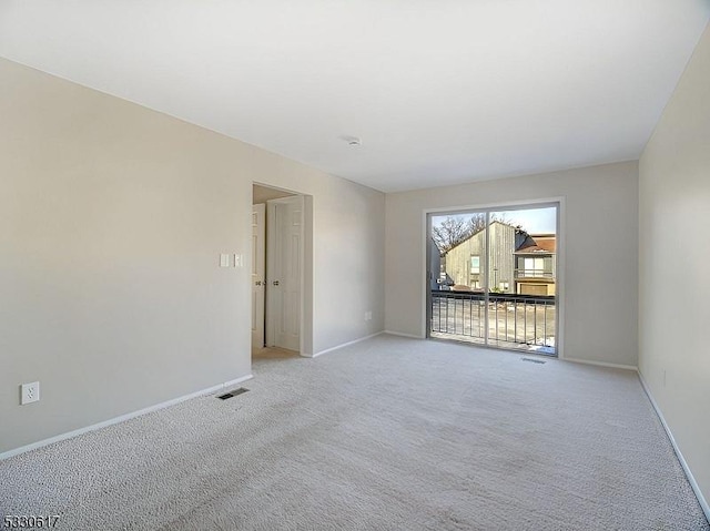 spare room featuring light carpet