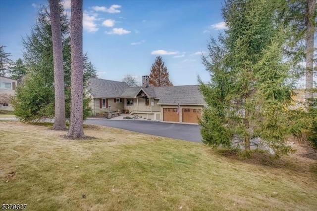 view of front of home with a garage and a front lawn