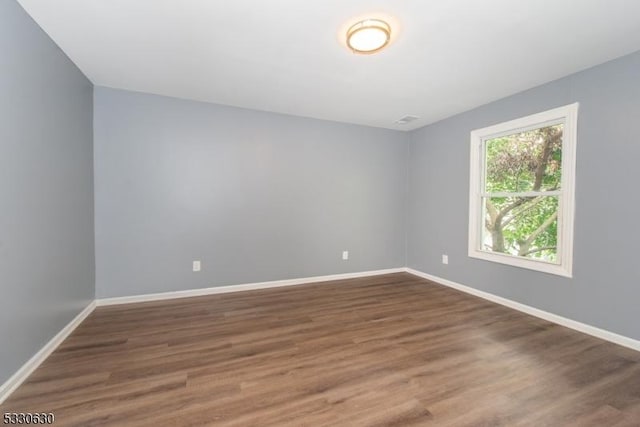 empty room featuring dark hardwood / wood-style flooring