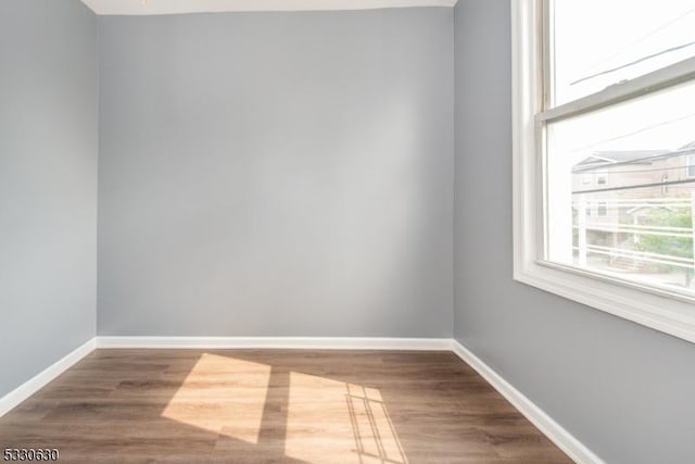 spare room with hardwood / wood-style floors