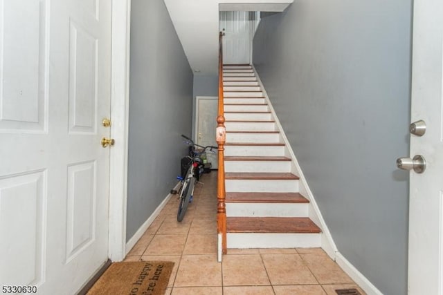 stairway with tile patterned floors