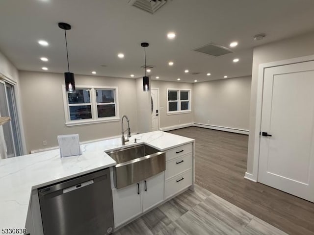 kitchen featuring white cabinets, a baseboard radiator, stainless steel dishwasher, and light stone counters