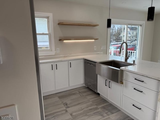 kitchen with dishwasher, white cabinetry, sink, and decorative light fixtures