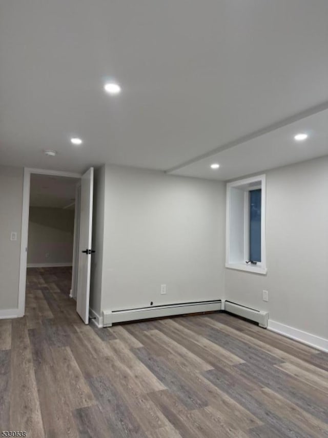 basement with hardwood / wood-style floors