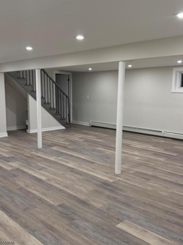 basement with hardwood / wood-style flooring