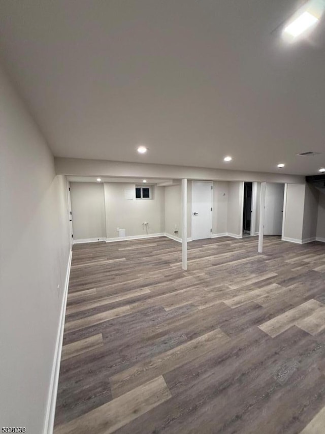 basement with hardwood / wood-style floors