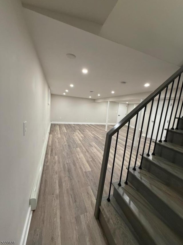 staircase with hardwood / wood-style flooring