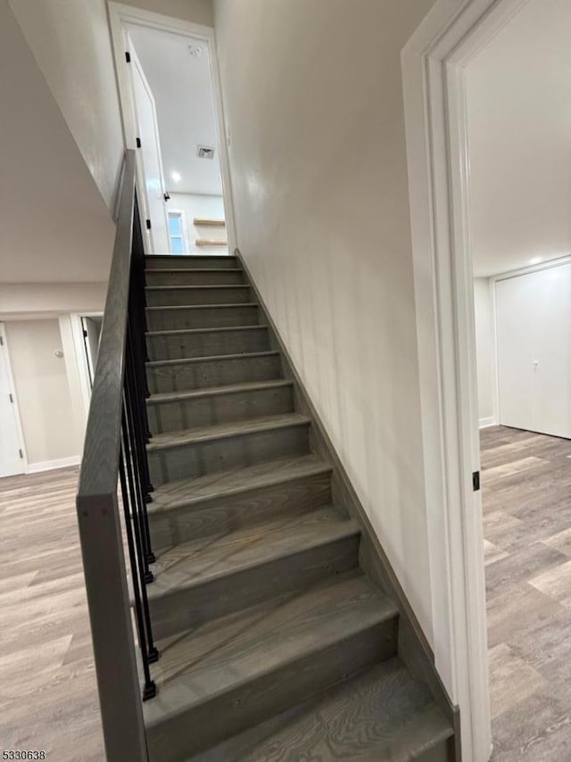 stairway with hardwood / wood-style flooring