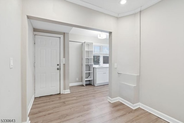 foyer entrance with light wood-type flooring, baseboards, and recessed lighting