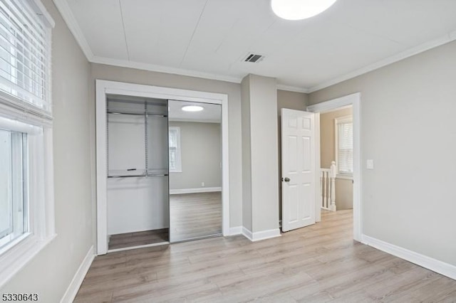 unfurnished bedroom with crown molding, baseboards, visible vents, and light wood-style floors