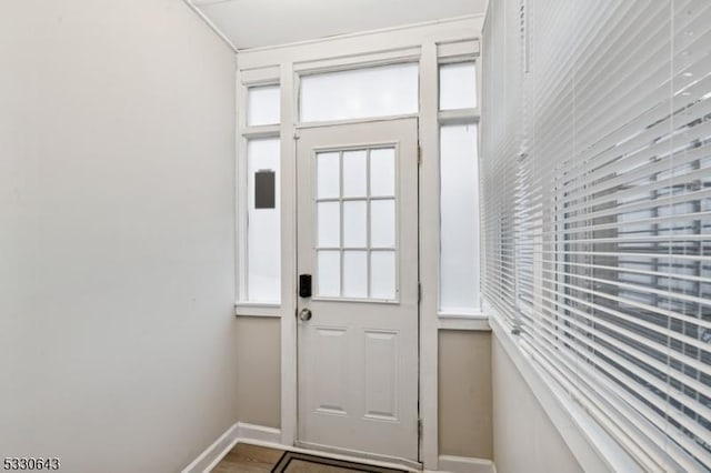 doorway to outside with baseboards