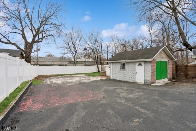 exterior space featuring an outdoor structure and a fenced backyard