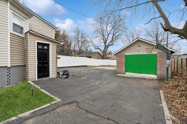 view of patio / terrace featuring an outbuilding and fence