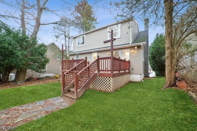 rear view of house featuring a wooden deck, a lawn, and a chimney