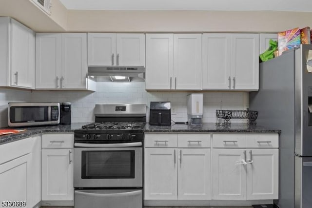 kitchen with backsplash, dark stone countertops, white cabinetry, and stainless steel appliances