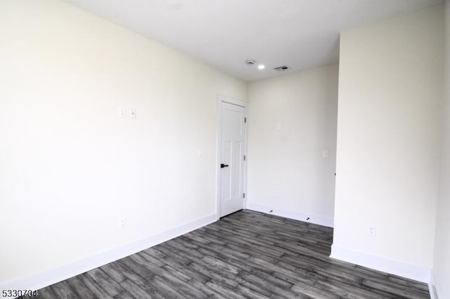 empty room with dark wood-type flooring