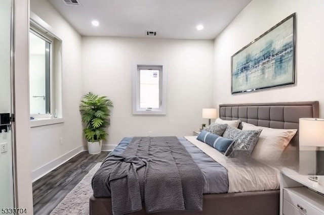 bedroom with dark hardwood / wood-style floors