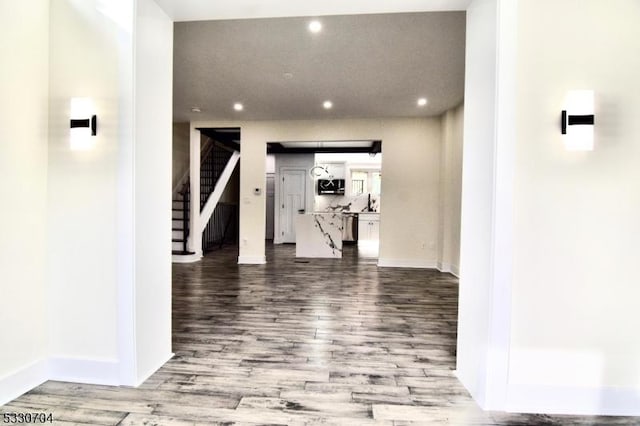 hallway with hardwood / wood-style floors