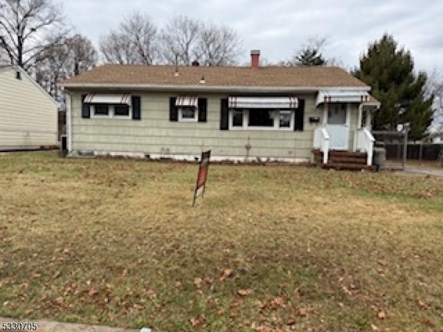 rear view of house with a lawn