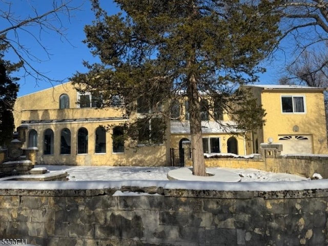 snow covered building with a garage