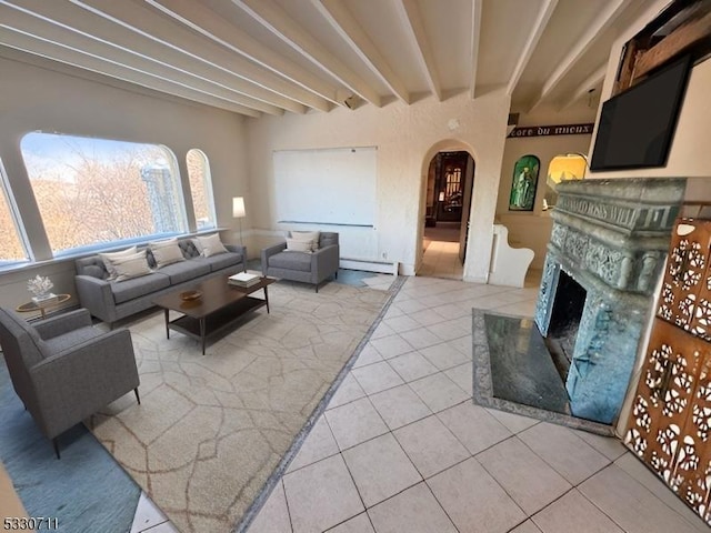 living room featuring tile patterned flooring, beamed ceiling, and a baseboard radiator