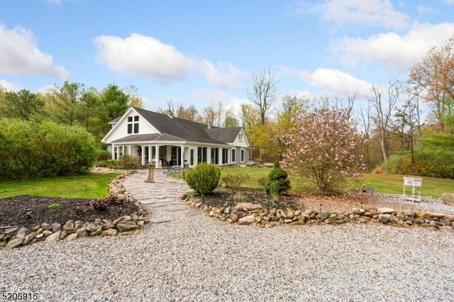 farmhouse inspired home with a front lawn