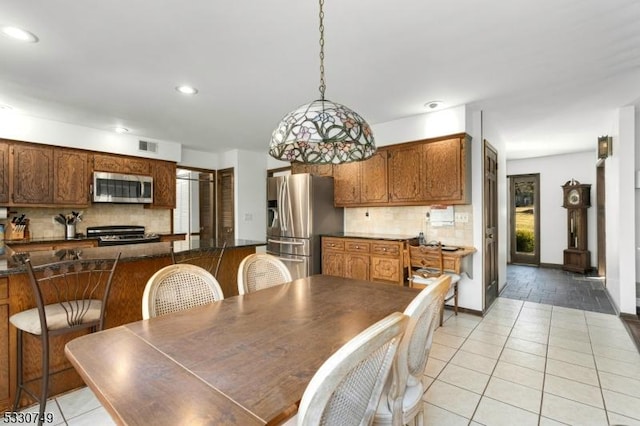 dining space with a healthy amount of sunlight and light tile patterned floors