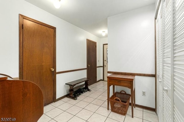 corridor with light tile patterned flooring