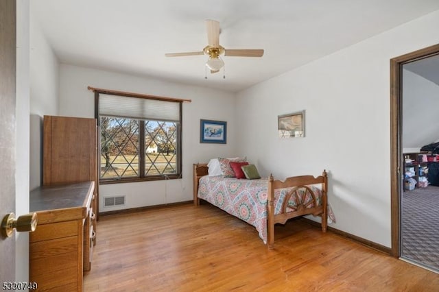 bedroom with ceiling fan and light hardwood / wood-style flooring